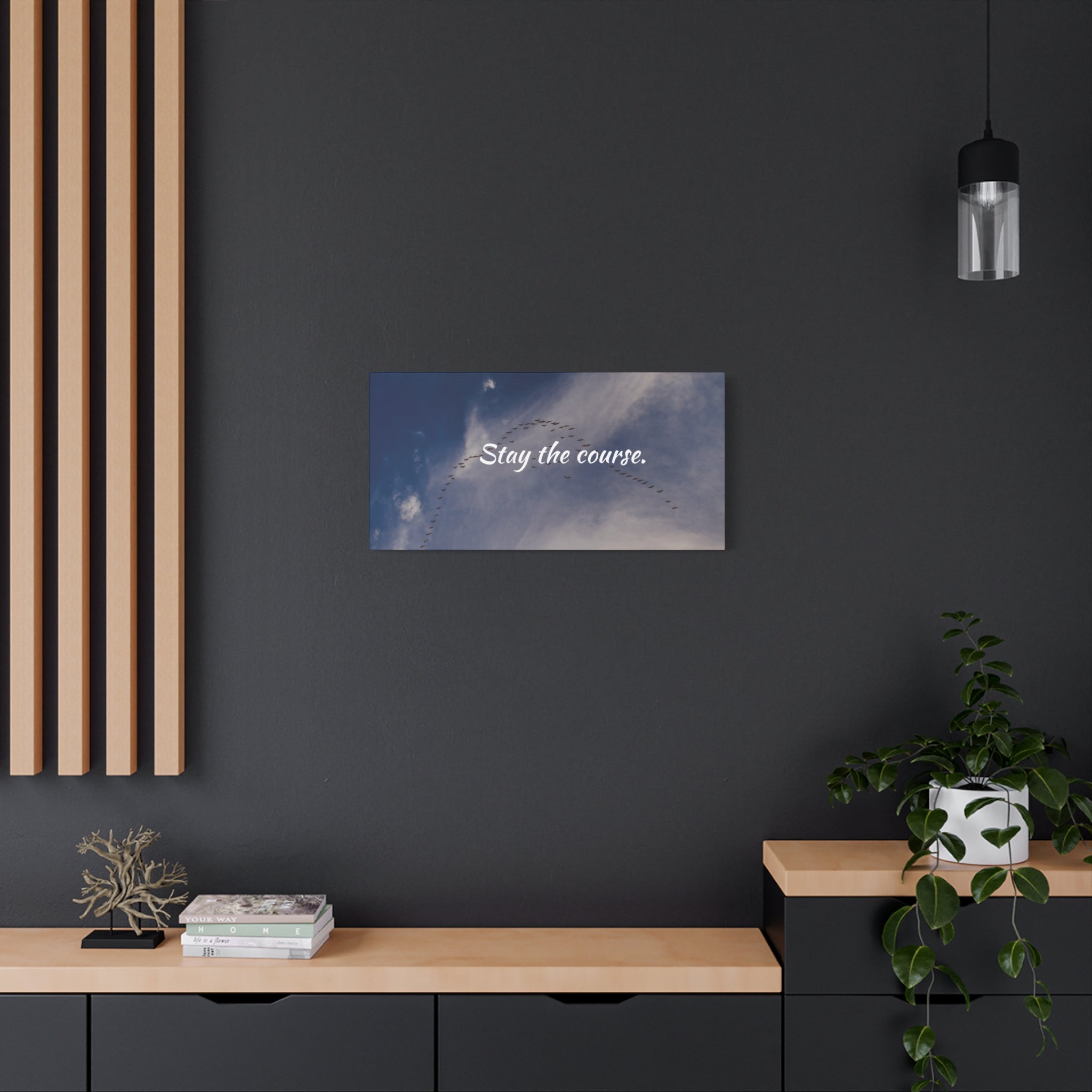 Wall art with motivational quote 'Stay the course.' in a modern interior setting.