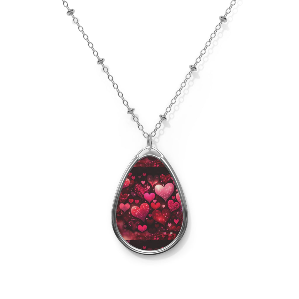 Teardrop-shaped pendant with heart design on a white background