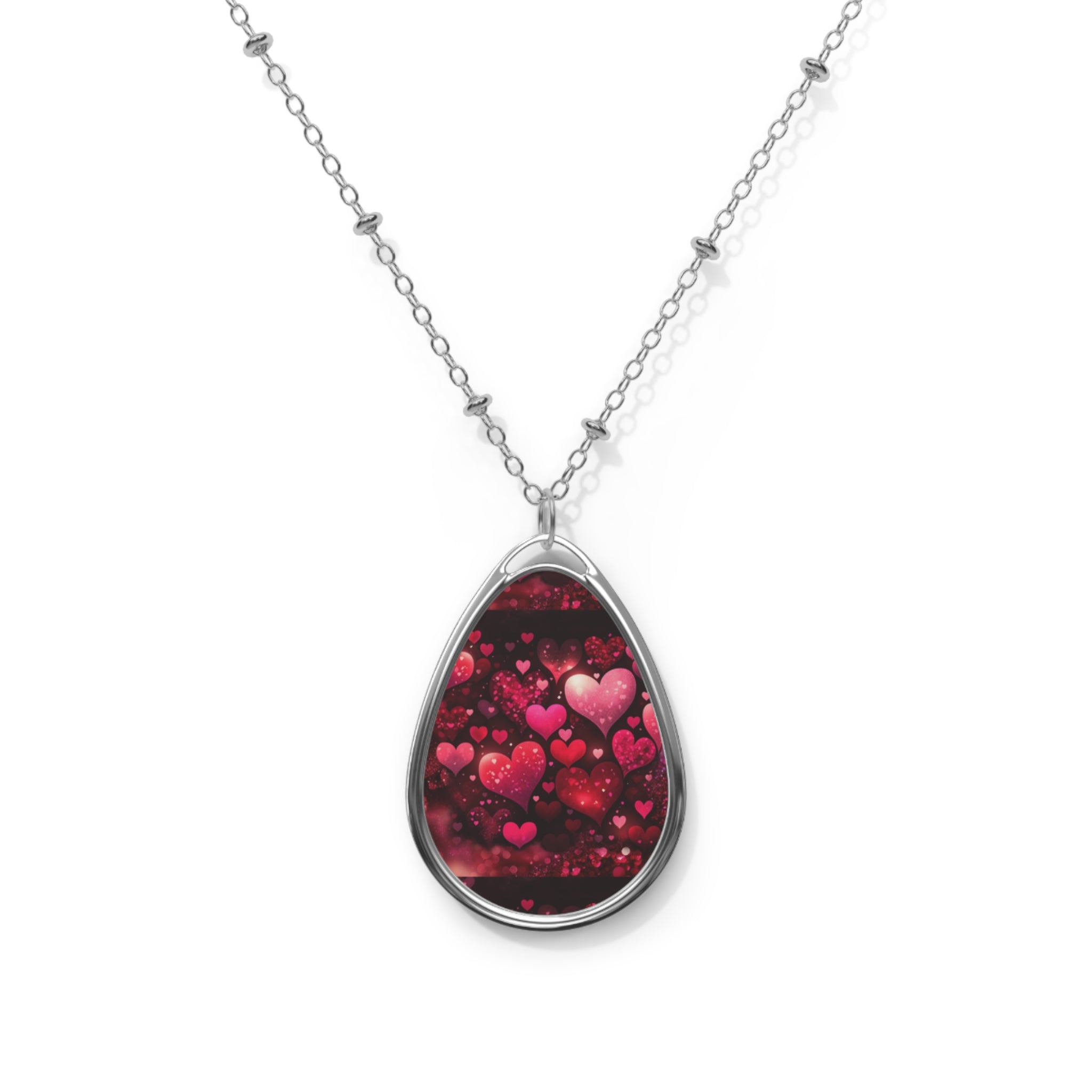 Teardrop-shaped pendant with heart design on a white background