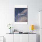 Framed artwork with 'Stay the course.' text on a wall above a white cabinet with decor items.