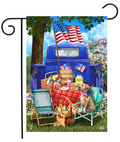Decorative flag with a picnic scene featuring a blue truck, American flags, and a dog.