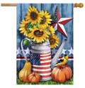 Decorative flag with sunflowers, American flag-themed watering can, pumpkins, and a bird on a wooden background.