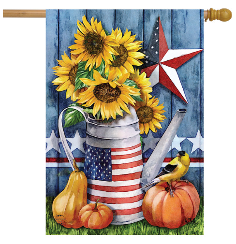 Decorative flag with sunflowers, American flag-themed watering can, pumpkins, and a bird on a wooden background.