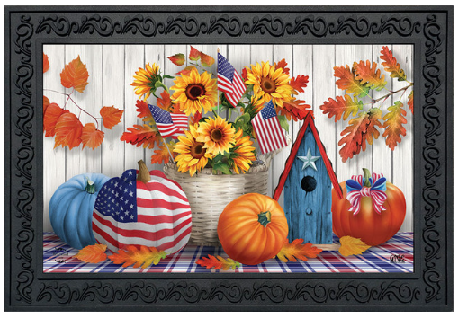 Decorative mat with autumn-themed elements including pumpkins, sunflowers, and American flags on a wooden background.