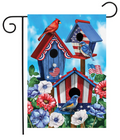 Decorative garden flag with patriotic birdhouses, birds, and flowers on a blue sky background.