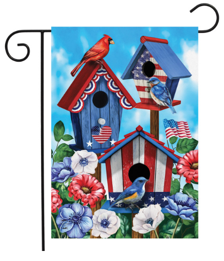 Decorative garden flag with patriotic birdhouses, birds, and flowers on a blue sky background.