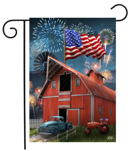 Decorative flag with a red barn, vintage truck, and American flag against a fireworks display background.