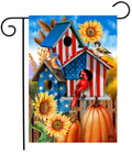 Decorative garden flag with American flag design, birds, sunflowers, and pumpkins on a blue sky background.