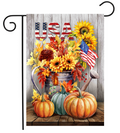 Decorative flag with pumpkins, sunflowers, and American flags on a wooden background