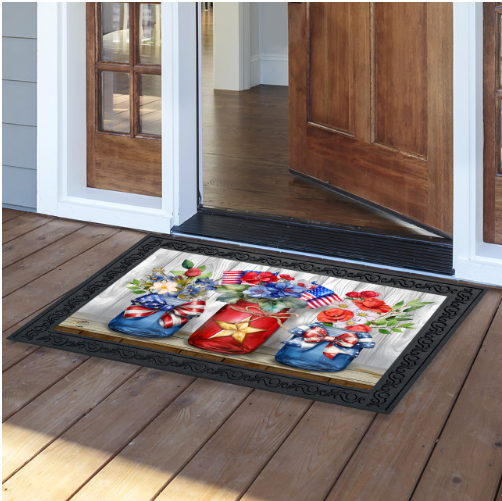 Decorative doormat with floral and gift design on a wooden floor.