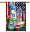 Decorative flag with floral arrangements and a heart-shaped jar against an American flag background