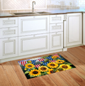 Decorative rug with sunflowers and American flags on a wooden floor in a kitchen.