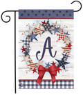 Decorative garden flag with stars, a bow, and the letter 'A' on a wooden background.