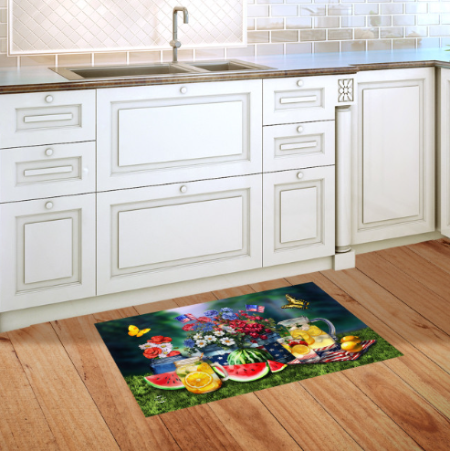 Decorative kitchen mat with a colorful design of fruits, flowers, and butterflies on a wooden floor.