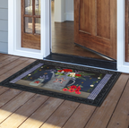 Decorative doormat with floral and star design on a wooden deck.