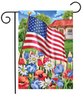 American flag with a garden scene featuring flowers and a house.