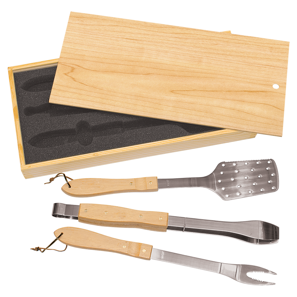 Set of four barbecue tools with wooden handles in a wooden box on a white background