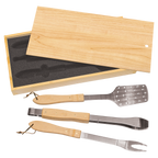 Set of four barbecue tools with wooden handles in a wooden box on a white background