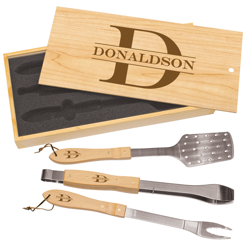 Set of three BBQ utensils with wooden handles and metal ends, displayed in a wooden box with 'Donaldson' branding.