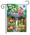 Decorative garden flag with birds and flowers around a birdbath.