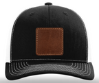 Black cap with a brown leather patch on a white background