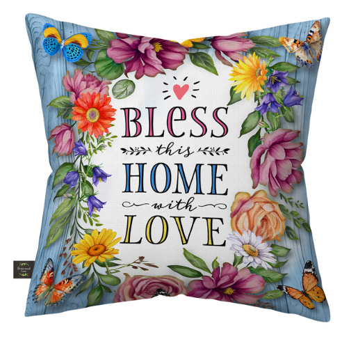 Decorative pillow with floral design and text 'Bless this home with love' on a white background