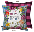 Decorative pillow with floral design and text 'Bless this home with love' on a blue background, with a checkered back.