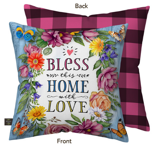 Decorative pillow with floral design and text 'Bless this home with love' on a blue background, with a checkered back.