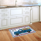 Decorative rug with a blue truck design on a wooden floor in a kitchen.