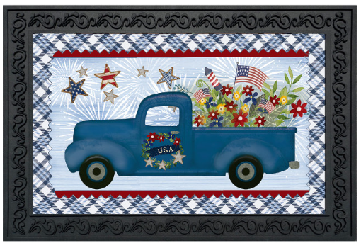 Decorative mat with a blue truck, American flags, and flowers on a plaid background.