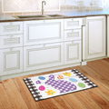 Decorative rug with a purple bunny design on a wooden floor in a kitchen.