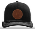 Black cap with a brown leather patch on a white background