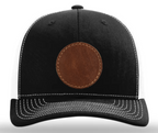 Black cap with a brown leather patch on a white background