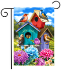 Decorative garden flag with colorful birdhouses and birds on a blue sky background.