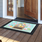 Decorative doormat with a basket of flowers design on a wooden floor.
