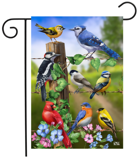 Decorative garden flag with colorful birds and flowers on a wooden post.