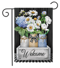 Decorative garden flag with flowers in jars and a 'Welcome' sign on a black and white checkered background.