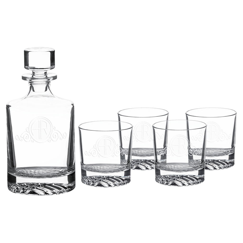 Clear glass decanter and four glasses with engraved logo on a white background