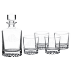 Clear glass decanter and four glasses with engraved logo on a white background