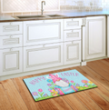 Decorative Easter mat with a gnome design on a wooden floor in a kitchen.