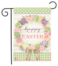 Decorative garden flag with Easter design featuring eggs, flowers, and a bow on a wooden background.