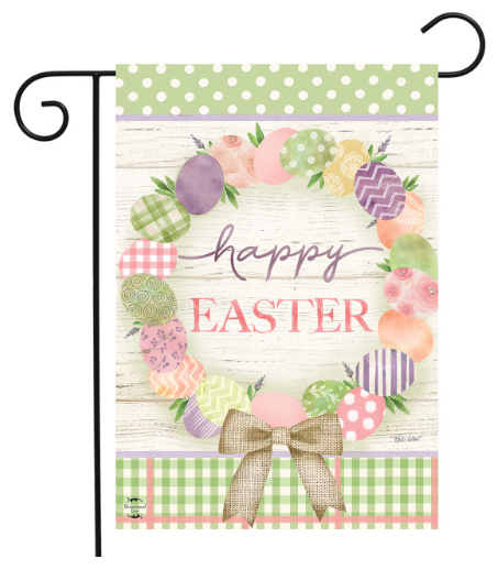 Decorative garden flag with Easter design featuring eggs, flowers, and a bow on a wooden background.