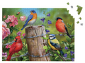 Jigsaw puzzle with colorful birds on a wooden post and flowers