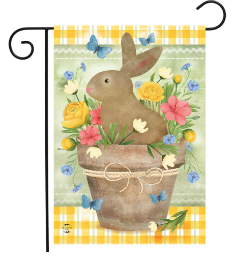 Decorative garden flag with a bunny in a basket surrounded by flowers and butterflies on a yellow and white checkered background.