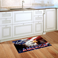 Kitchen with a decorative mat featuring an eagle and 'God Bless America' text on a wooden floor.