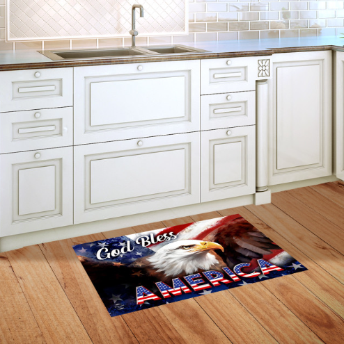 Kitchen with a decorative mat featuring an eagle and 'God Bless America' text on a wooden floor.