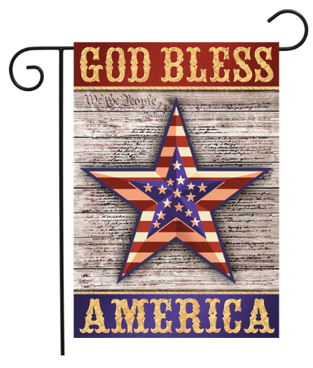 Decorative flag with 'God Bless America' text and a star design on a wooden background.