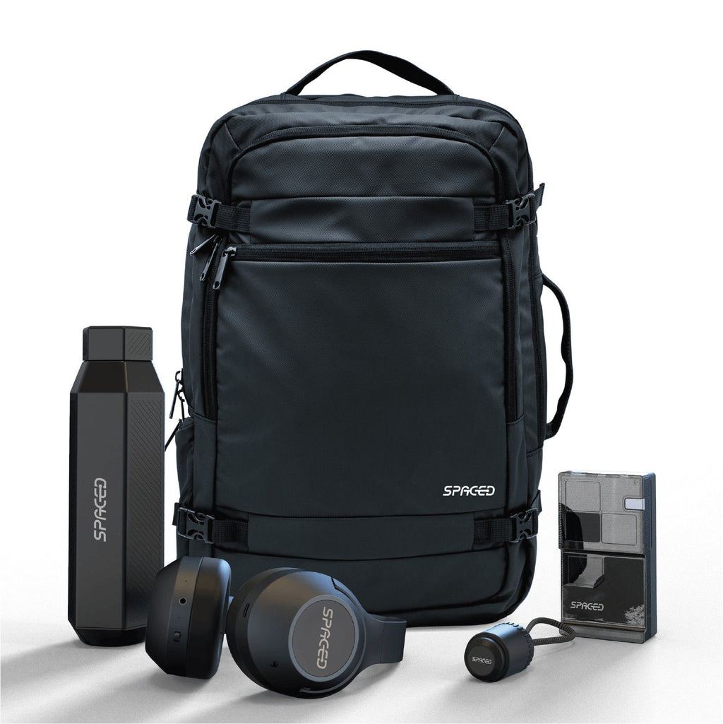 Black backpack with Spaced branding, including a water bottle, headphones, and a small device on a white background.