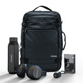 Black backpack with Spaced branding, including a water bottle, headphones, and a small device on a white background.