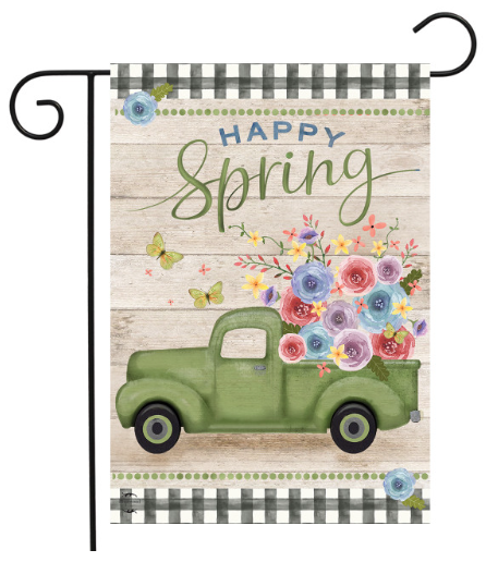 Decorative garden flag with a vintage truck, flowers, and 'Happy Spring' text on a wooden background.